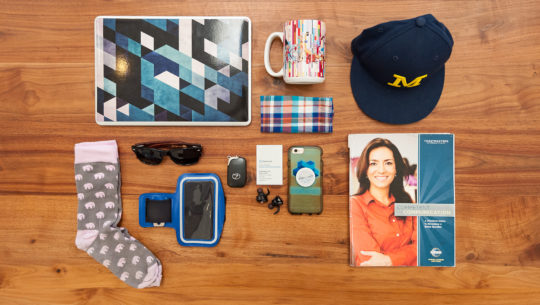 Image of magazine, macbook, hat, sunglasses, wallet, iphone, earphones, cup