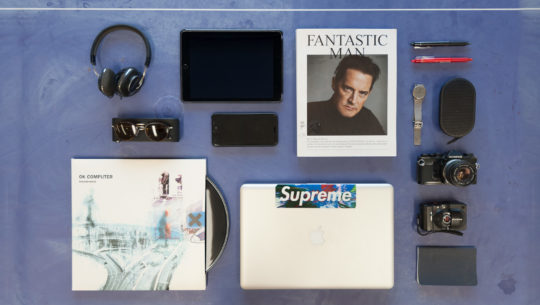 Image of book, macbook, ipad, camera, pens, watch, earphones, records